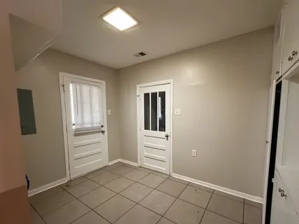 a view of a hallway to rooms and stairs