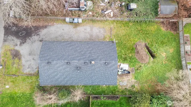 an aerial view of a house with a yard and lake view