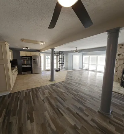a kitchen with granite countertop a refrigerator and a sink