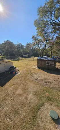a view of a yard with a tree