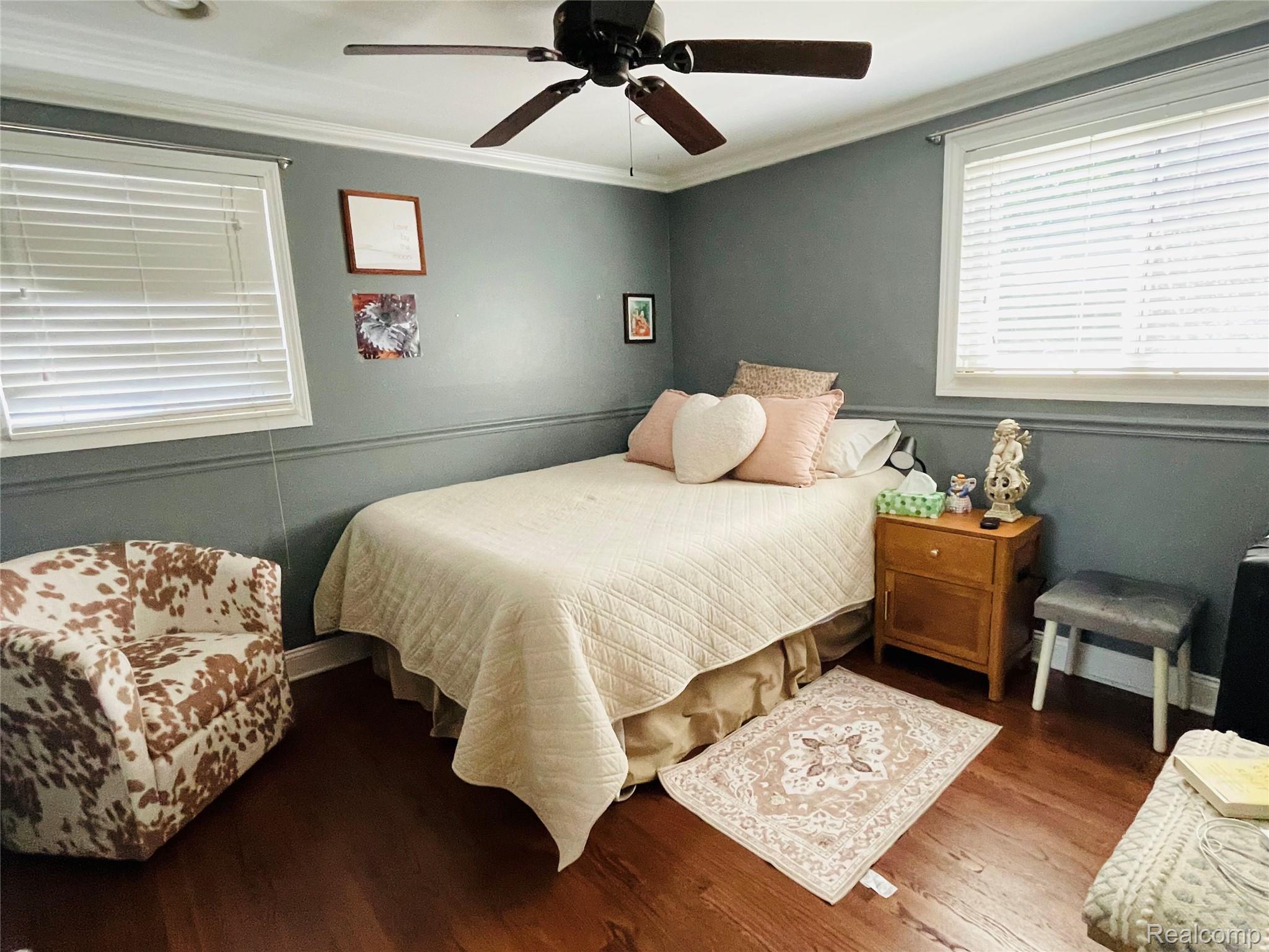488 Welch Road Northville, MI 48167 - Photo 11 of 22 Room with wood-finish flooring, a ceiling fan, and white crown molding
