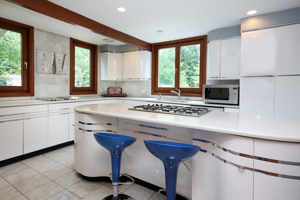 47 Dudley Road Newton, MA 02459 - Photo 4 of 21 a kitchen with stainless steel appliances kitchen island granite countertop a sink and a stove