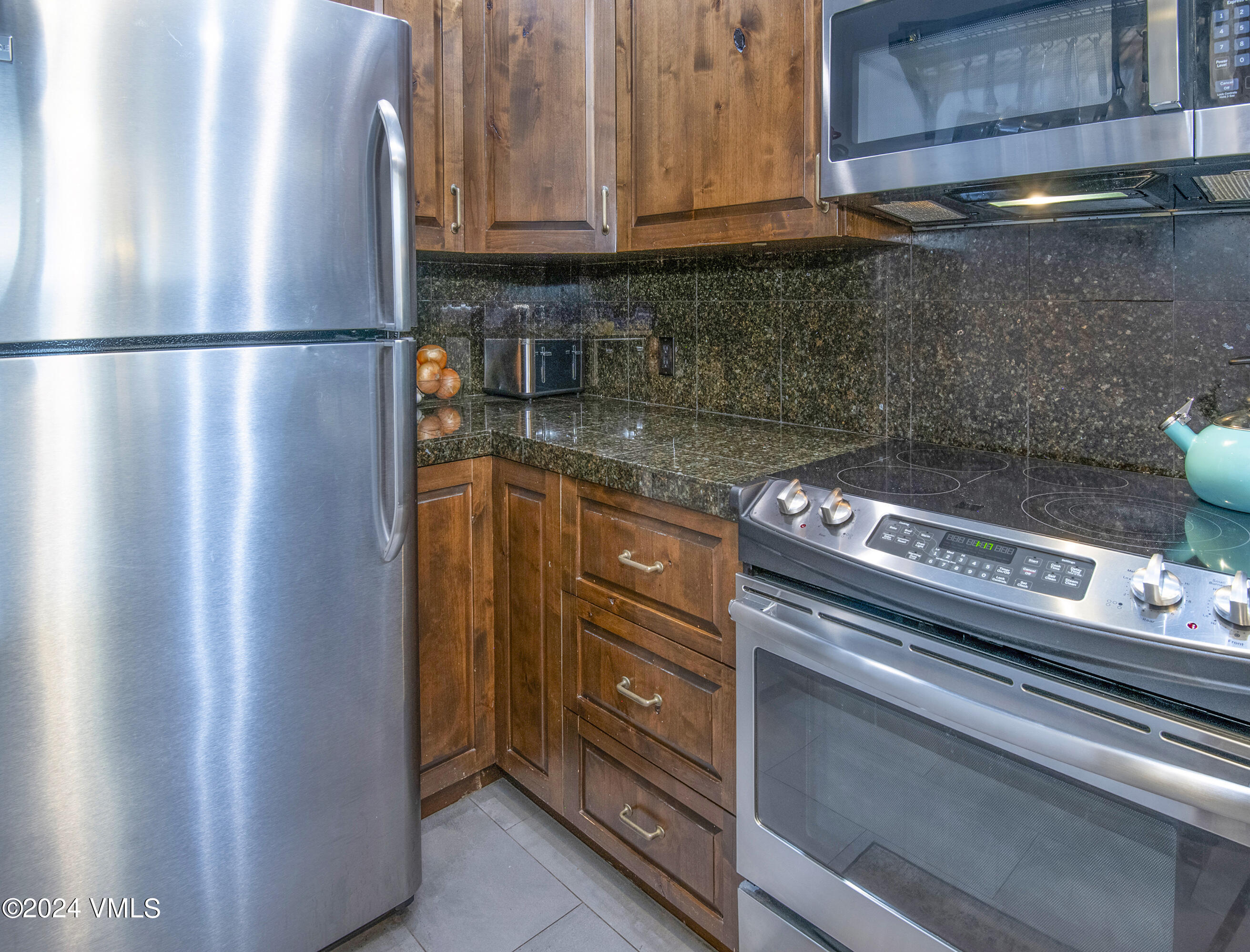 600 Nottingham Road, Unit 5 Avon, CO 81620 - Photo 5 of 13 a kitchen with stainless steel appliances granite countertop a refrigerator and a stove