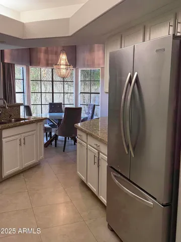a kitchen with a refrigerator and a sink