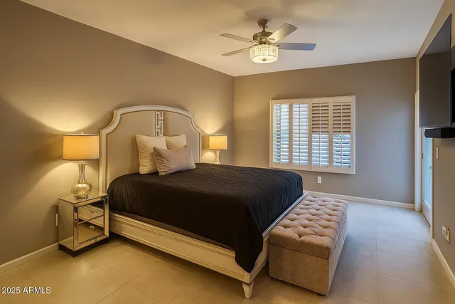 a bedroom with a bed and a window