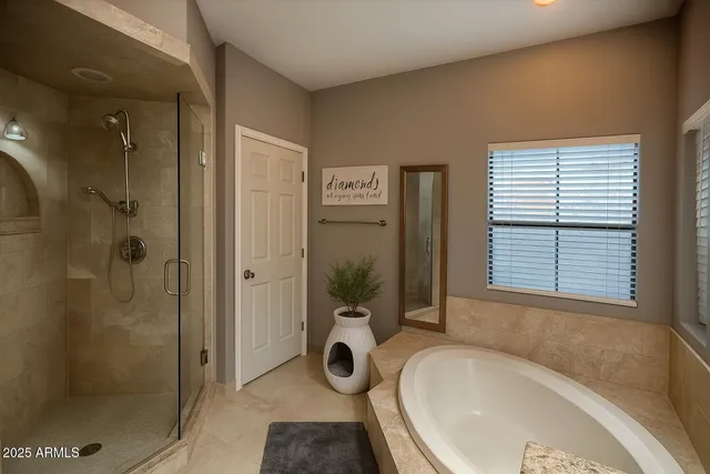 a bathroom with a tub and shower