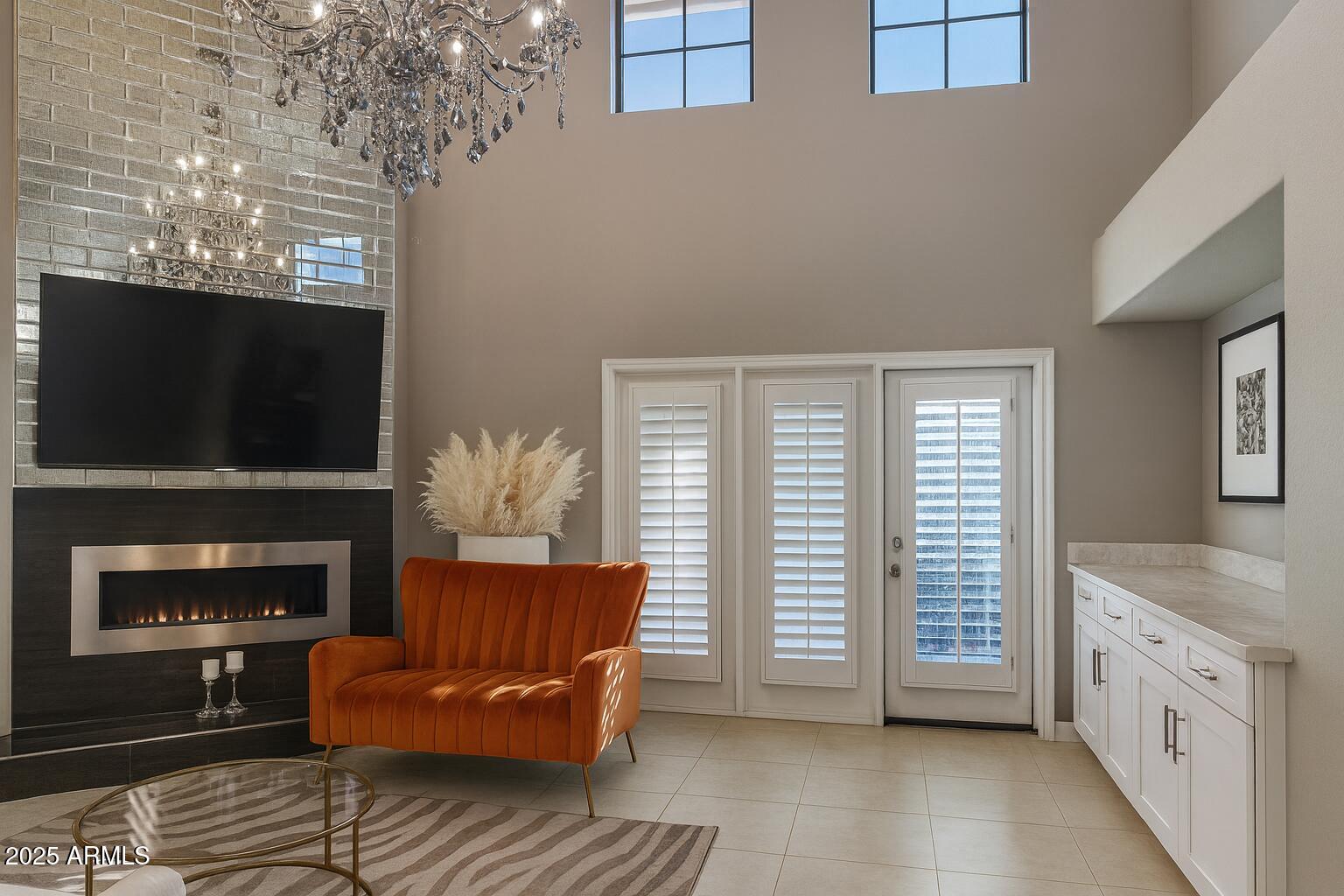 8100 East Camelback Road, Unit 163 Scottsdale, AZ 85251 - Photo 9 of 51 a living room with furniture a flat screen tv and a fireplace