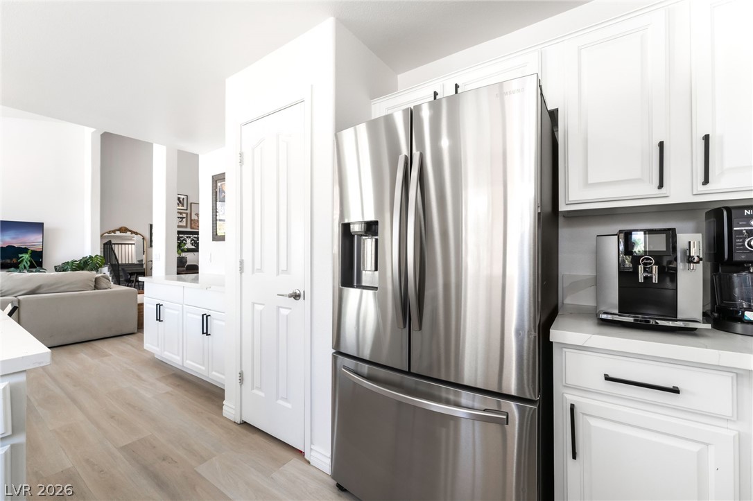 1941 Ivy Point Lane Las Vegas, NV 89134 - Photo 9 of 21 This bright kitchen and living area feature stainless steel appliances and durable hardwood flooring.