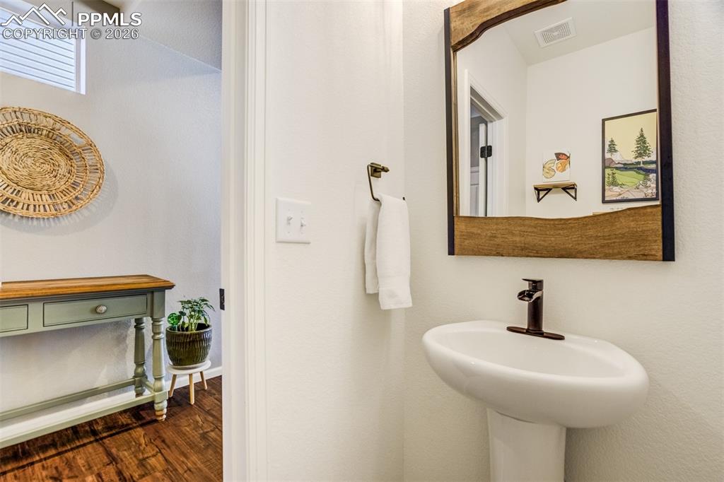 6374 Moate Lane Colorado Springs, CO 80927 - Photo 12 of 42 a bathroom with a sink a mirror and vanity