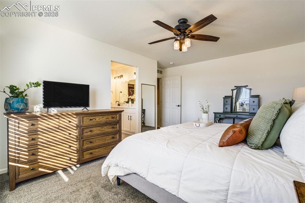 6374 Moate Lane Colorado Springs, CO 80927 - Photo 16 of 42 a bedroom with a bed and a flat screen tv