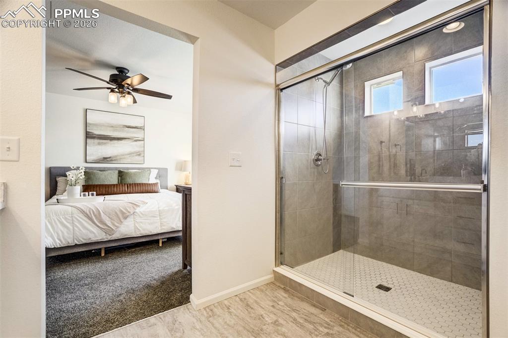 6374 Moate Lane Colorado Springs, CO 80927 - Photo 18 of 42 a bedroom with a bed and a walk in closet