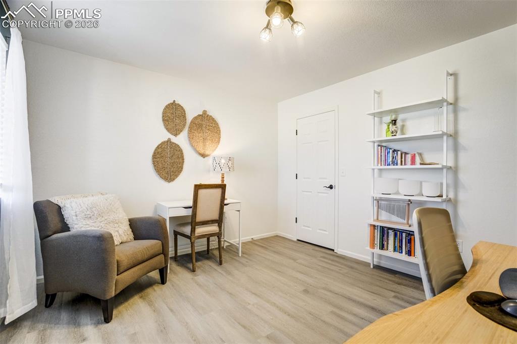 6374 Moate Lane Colorado Springs, CO 80927 - Photo 24 of 42 a living room with furniture and a book shelf