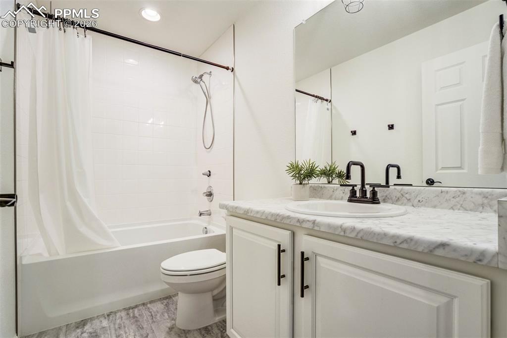 6374 Moate Lane Colorado Springs, CO 80927 - Photo 27 of 42 a bathroom with a granite countertop sink toilet and shower