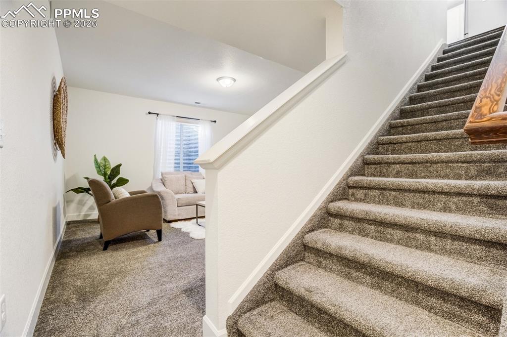 6374 Moate Lane Colorado Springs, CO 80927 - Photo 28 of 42 a living room with furniture and stairs