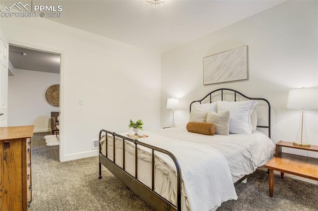 6374 Moate Lane Colorado Springs, CO 80927 - Photo 33 of 42 a bedroom with bed and a table