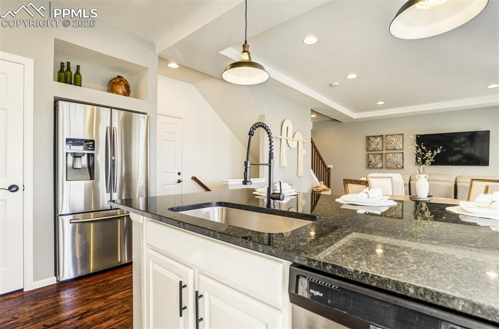 6374 Moate Lane Colorado Springs, CO 80927 - Photo 10 of 42 a kitchen with granite countertop a sink stainless steel appliances and cabinets