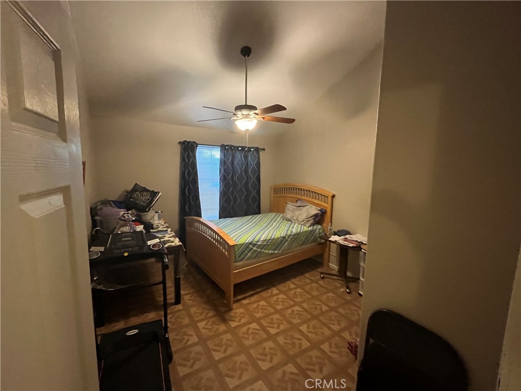 740 Hazelhurst Way Coalinga, CA 93210 - Photo 15 of 19 a bedroom with a bed and a chandelier