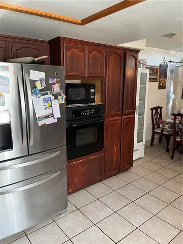 a kitchen with stainless steel appliances granite countertop a refrigerator and a stove top oven
