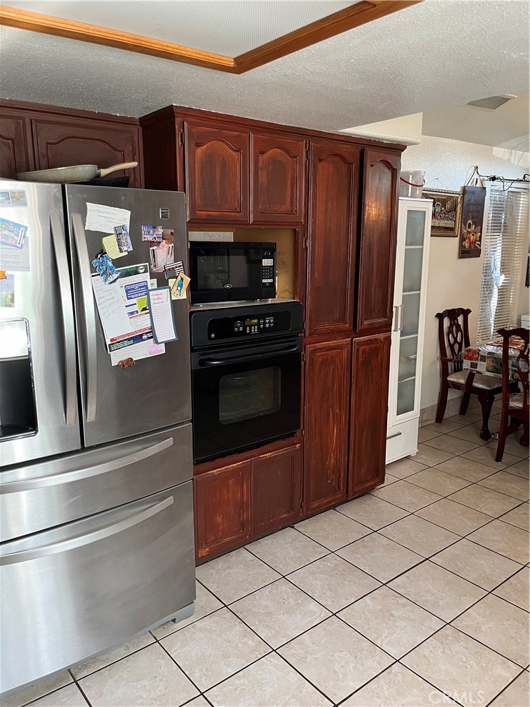 740 Hazelhurst Way Coalinga, CA 93210 - Photo 9 of 19 a kitchen with stainless steel appliances granite countertop a refrigerator and a stove top oven