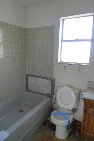 513 East Tulane Street Lubbock, TX 79403 - Photo 5 of 10 a white toilet sitting next to a bath tub