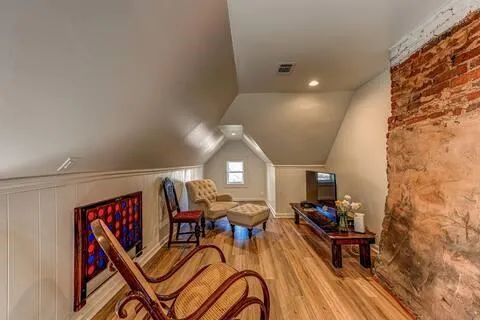 a view of a room with furniture and wooden floor