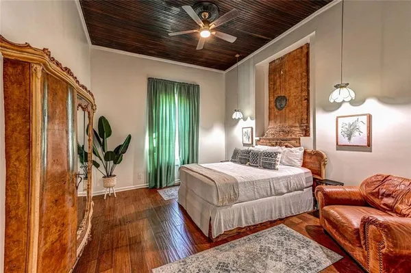 a bedroom with bed and wooden floor