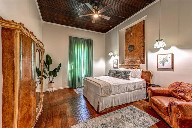 a bedroom with bed and wooden floor