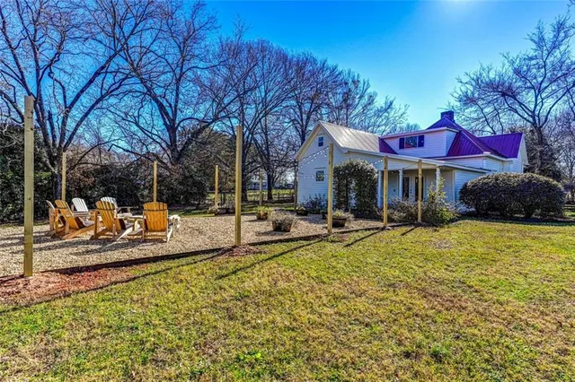 a view of a house with swimming pool and sitting area