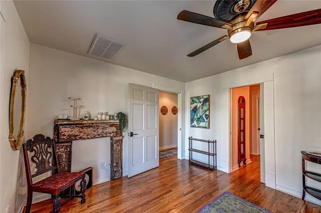 a view of a livingroom with furniture a ceiling fan and wooden floor