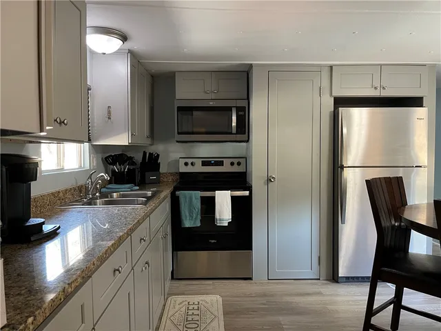 a stove top oven sitting inside of a kitchen
