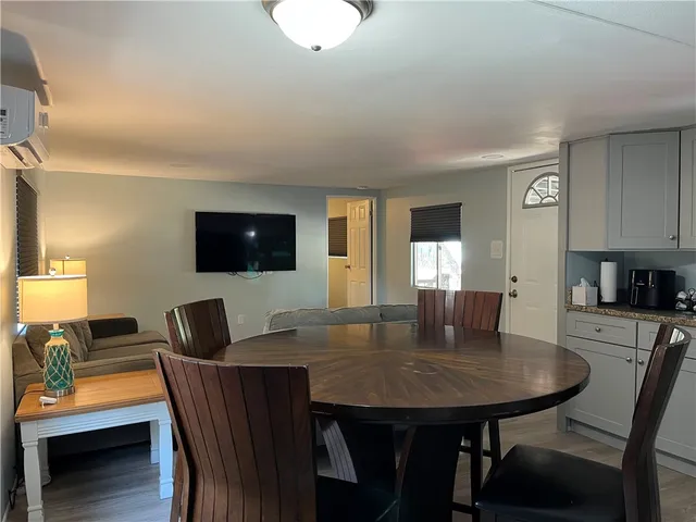 a view of hallway with a closet and wooden floor