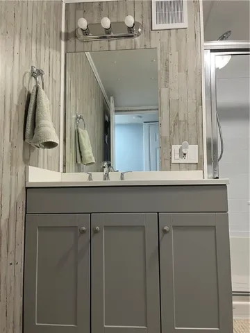 a bathroom with a glass shower door