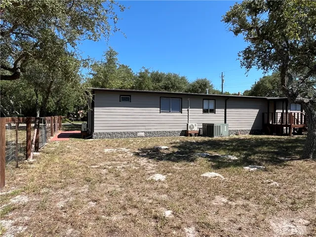a view of a yard with a tree