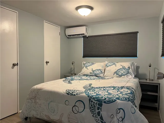 a bedroom with a bed and a painting on the wall