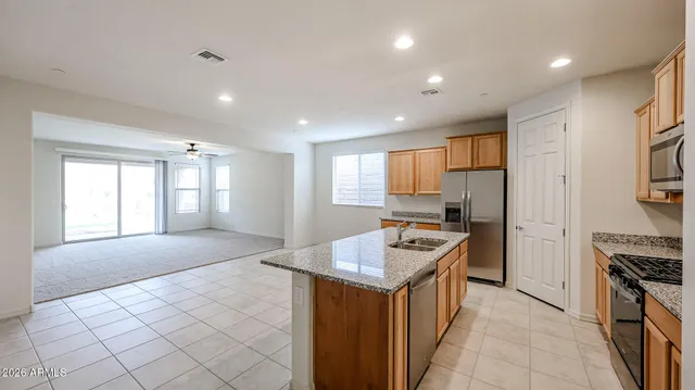 a kitchen with a sink a counter top space and stainless steel appliances