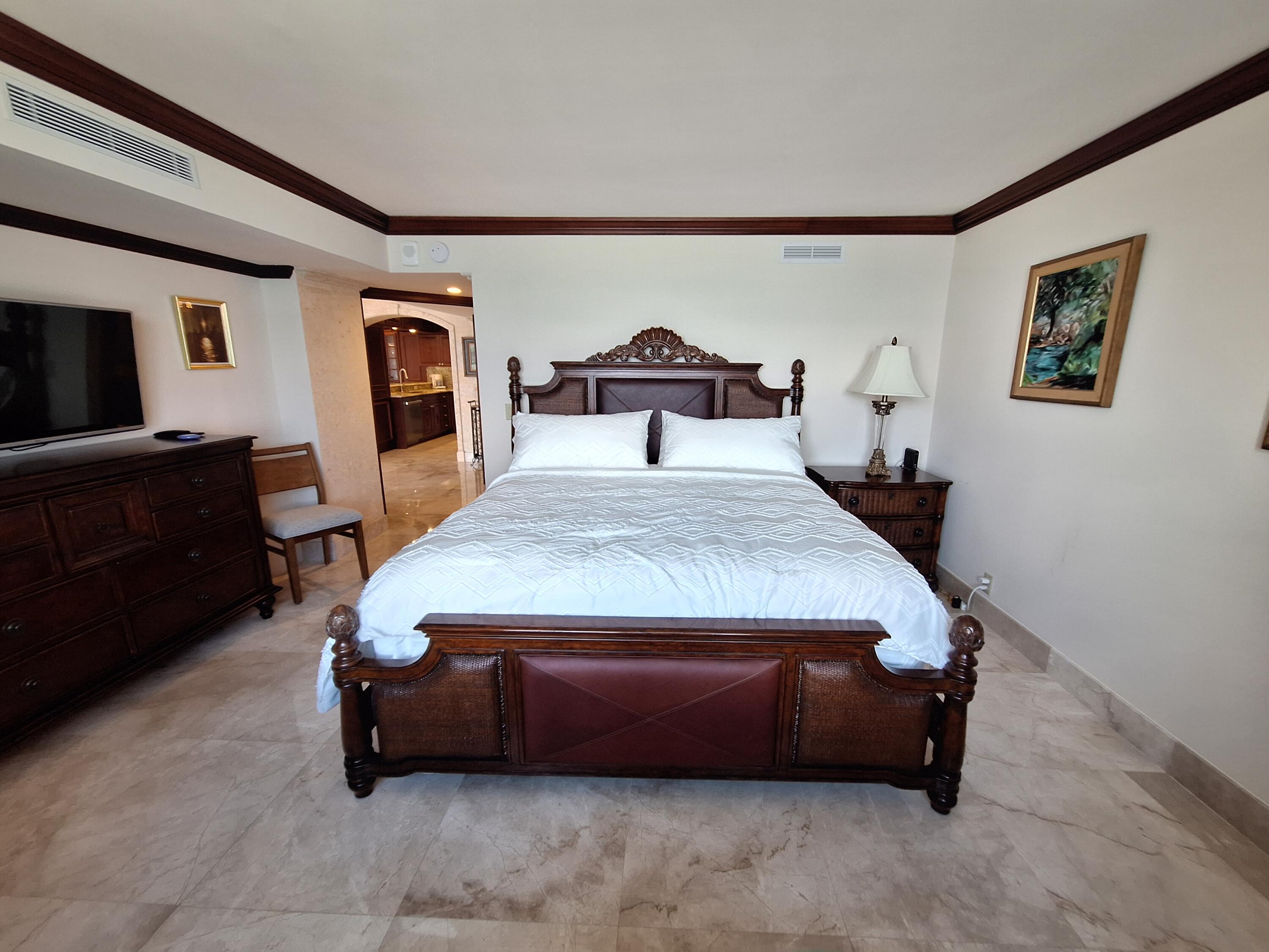 3400 North Ocean Drive, Unit PH2 Singer Island, FL 33404 - Photo 17 of 38 a bedroom with a bed and wooden floor