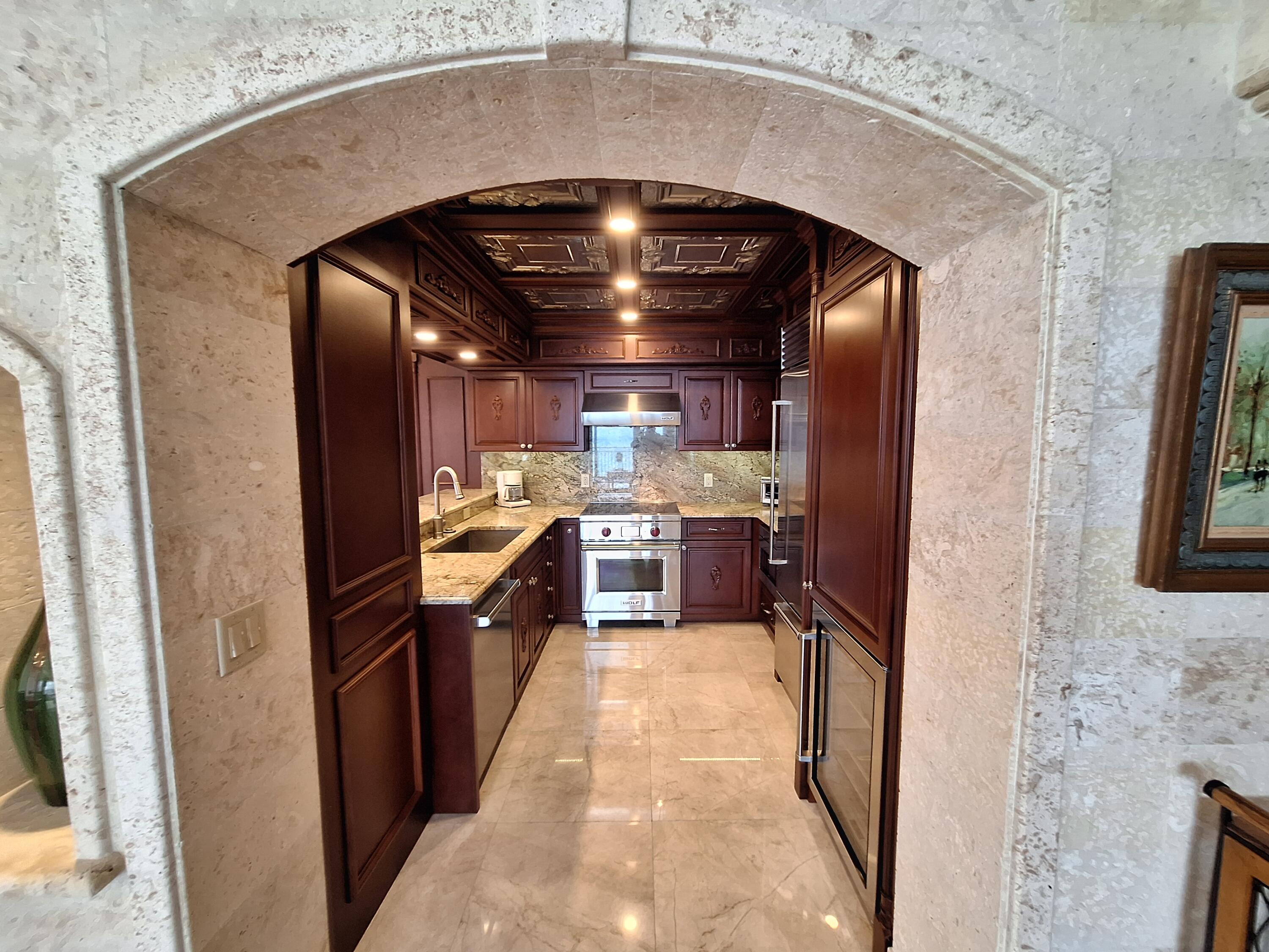 3400 North Ocean Drive, Unit PH2 Singer Island, FL 33404 - Photo 19 of 38 a kitchen with stainless steel appliances granite countertop a sink and a refrigerator