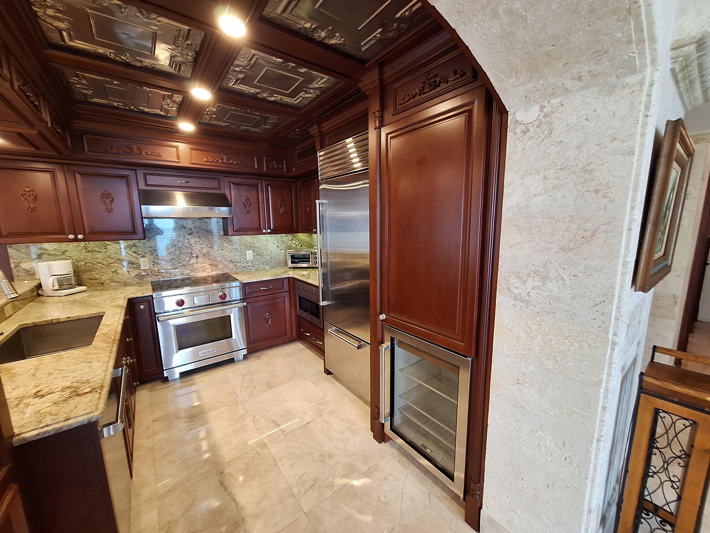 3400 North Ocean Drive, Unit PH2 Singer Island, FL 33404 - Photo 20 of 38 a kitchen with stainless steel appliances granite countertop a refrigerator and a sink