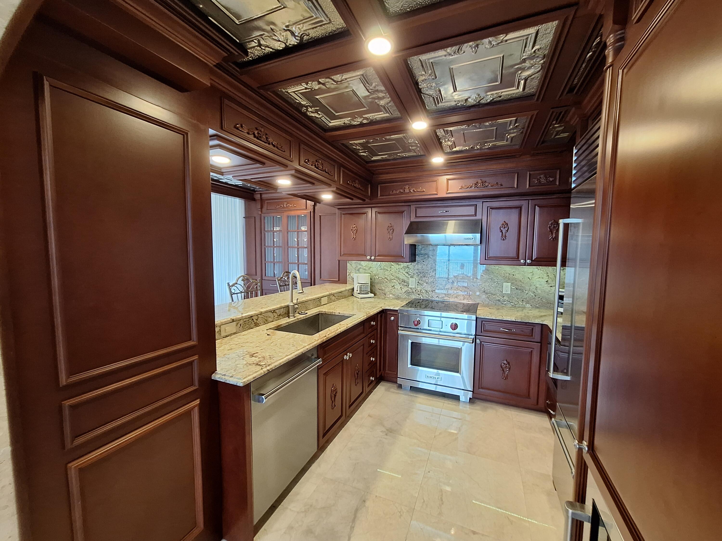 3400 North Ocean Drive, Unit PH2 Singer Island, FL 33404 - Photo 21 of 38 a large kitchen with a stove and a refrigerator