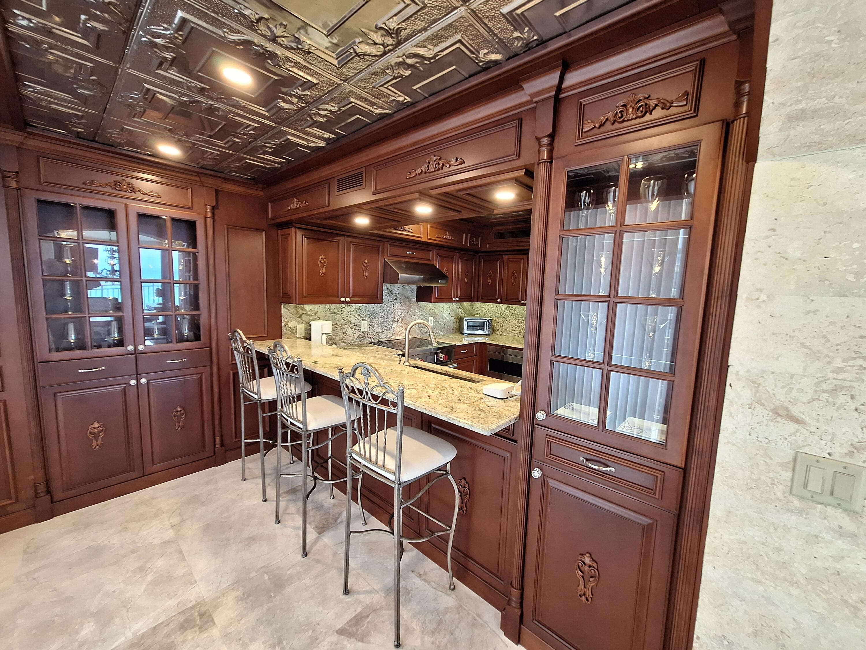 3400 North Ocean Drive, Unit PH2 Singer Island, FL 33404 - Photo 24 of 38 a dining room with furniture and a chandelier