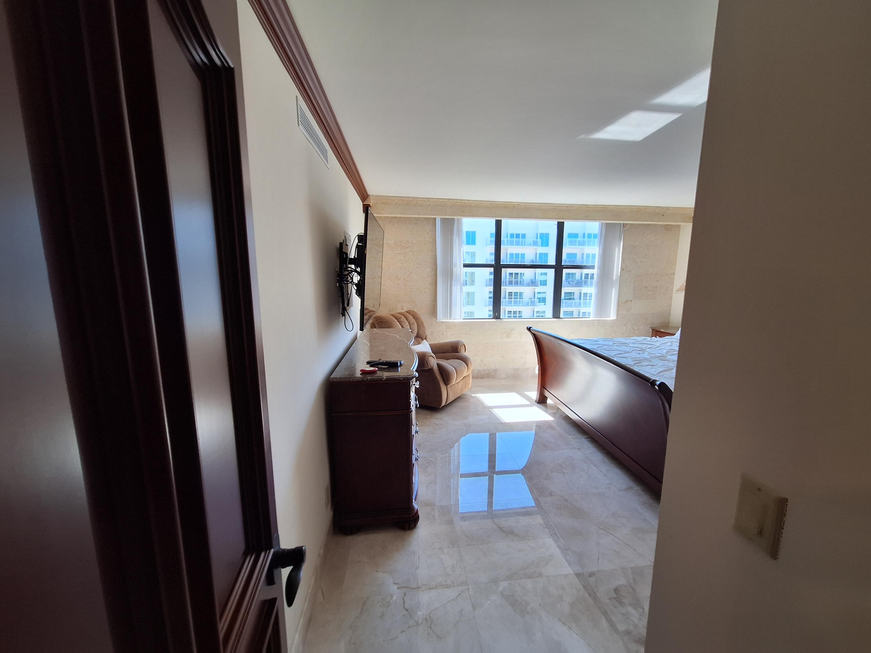 3400 North Ocean Drive, Unit PH2 Singer Island, FL 33404 - Photo 32 of 38 a living room with furniture and a window