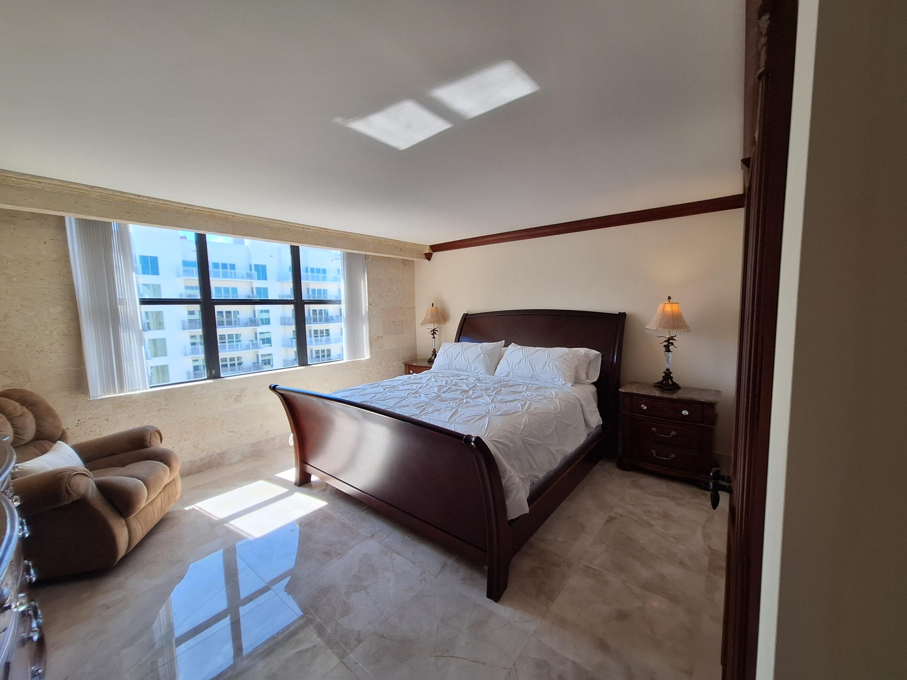 3400 North Ocean Drive, Unit PH2 Singer Island, FL 33404 - Photo 33 of 38 a bedroom with a bed and a large window