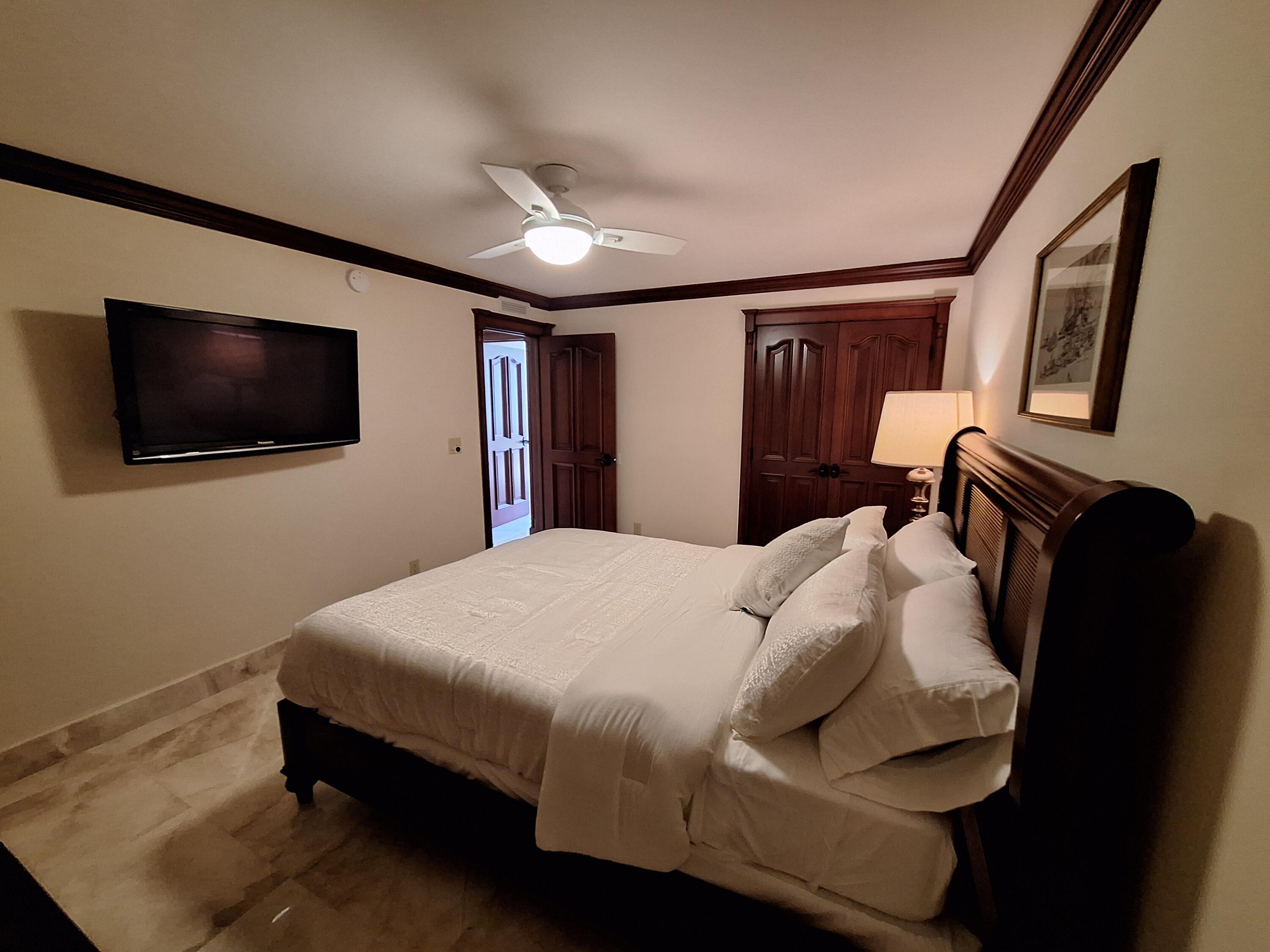 3400 North Ocean Drive, Unit PH2 Singer Island, FL 33404 - Photo 38 of 38 a bedroom with a bed a flat screen tv and dresser