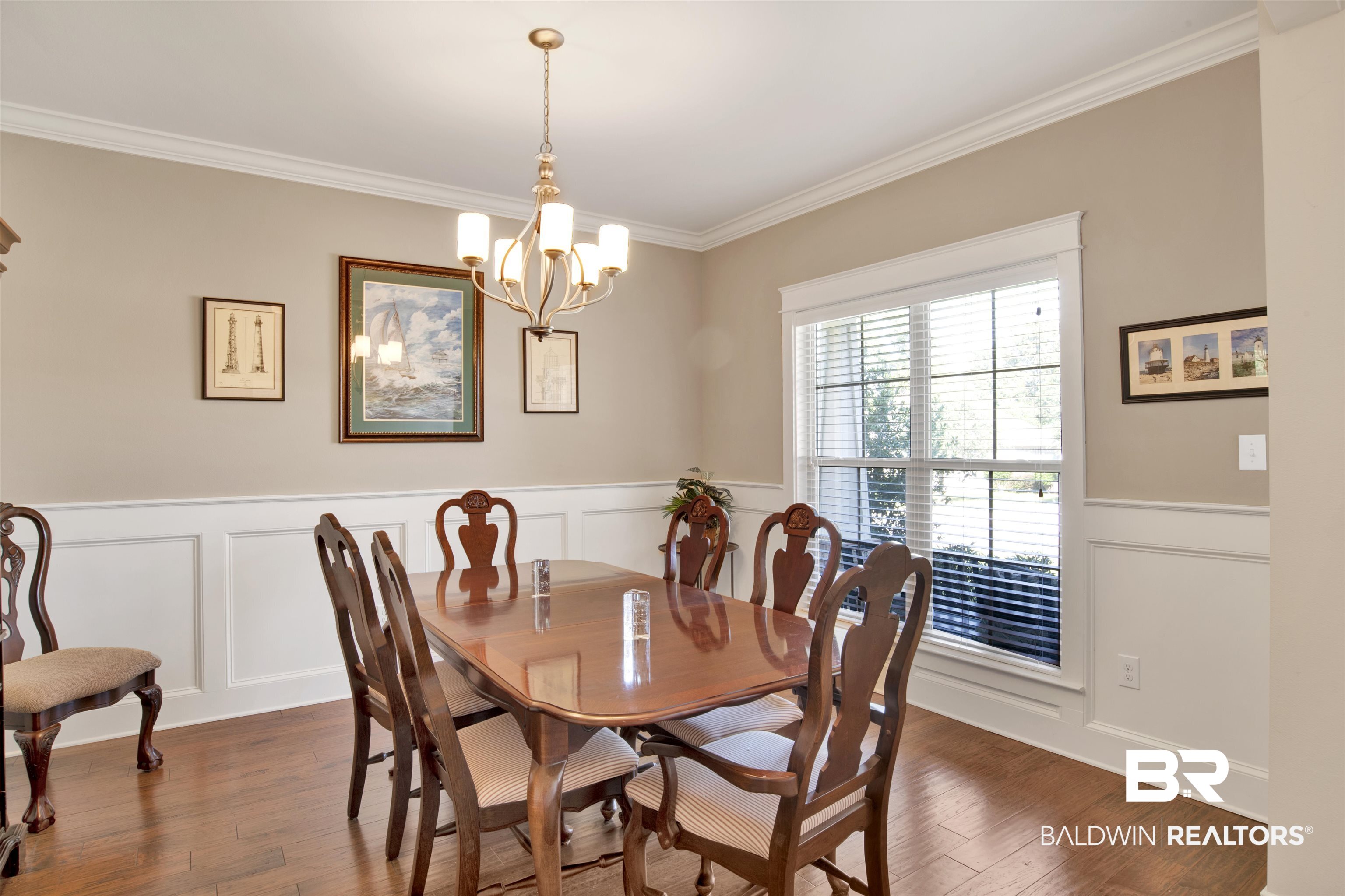 360 Scarlett Avenue Fairhope, AL 36532 - Photo 6 of 34 Dining room featuring ornamental molding, a chandelier, and dark hardwood / wood-style flooring
