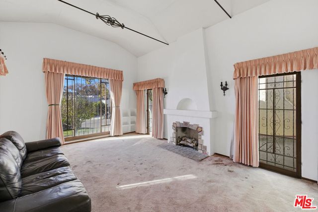 a view of livingroom with furniture and a fireplace