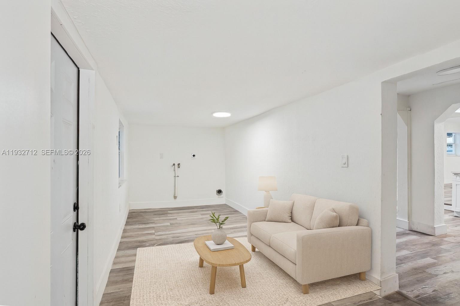 724 Burlington Street Opa-Locka, FL 33054 - Photo 14 of 15 a living room with furniture and a wooden floor