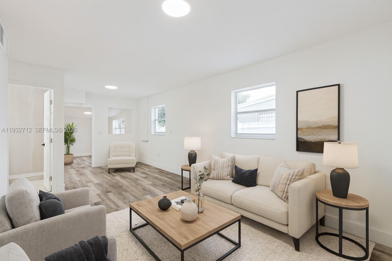 724 Burlington Street Opa-Locka, FL 33054 - Photo 2 of 15 a living room with furniture and a wooden floor