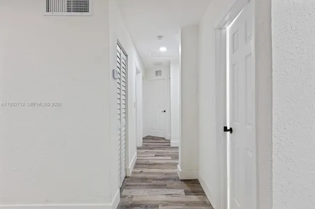 a view of a hallway with stairs