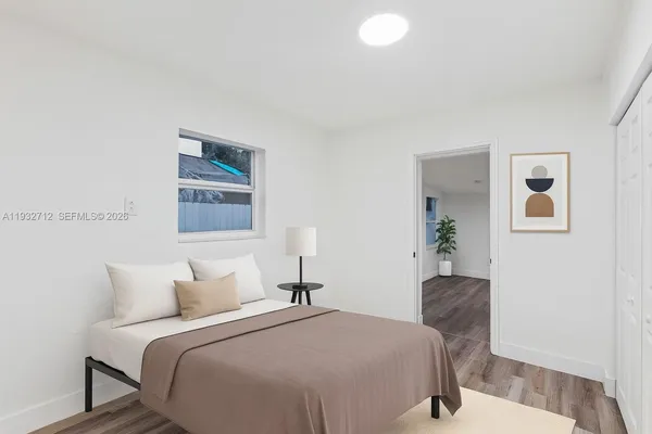 a bedroom with bed and painting on the wall