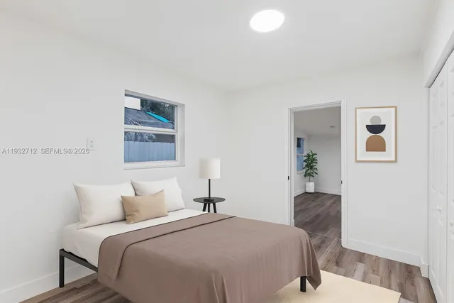 a bedroom with bed and painting on the wall